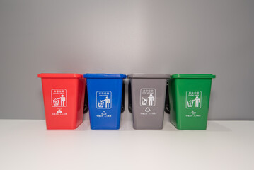 Four trash cans with symbols of waste sorting, sustainable development, recycling resources