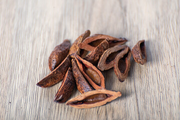 Dried betel nut products on wooden table and in bamboo basket