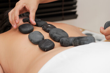 relaxation massage with volcanic stones, relaxation and mental health healing concept