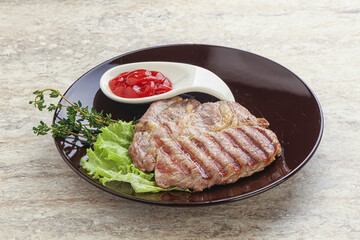 Grilled pork neck steak with ketchup