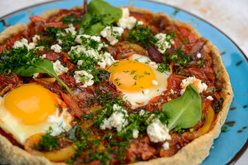 shakshuka in dough in a blue plate macro photo
