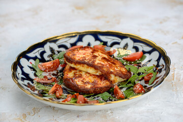 fried chicken fillet in a bowl with tomatoes and greens
