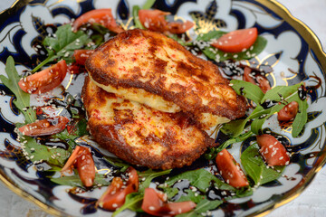 fried chicken fillet in a bowl with tomatoes and greens macro photo
