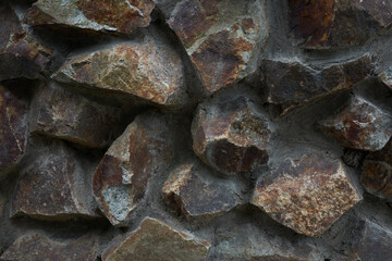 Close-up view of rough stone wall textured background