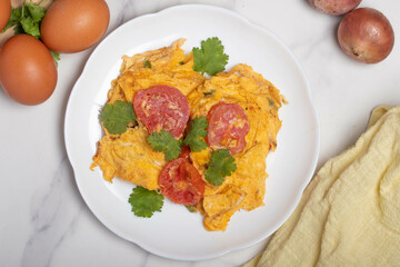Oil-free tomato omelette in a white plate. Healthy food ideas for weight loss.