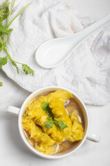 Wonton Soup Clear soup in a white cup.