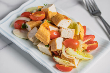 Fried tofu salad with fresh vegetables. Weight loss diet.