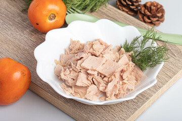canned tuna in white plate on wooden background