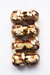 fried sushi rolls with sauce and almonds on white background for menu