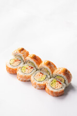 sushi rolls with shrimp, avocado and sauce on a white background