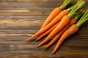 Fresh carrots on brown texture background. Ingredient for salad.Vegetarian organic vegetables.Healthy food.Copy space.Place for text