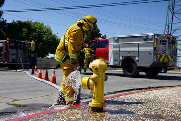 San Jose Fire Fighter Prepping a fire hydrant to fight a fire