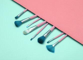Makeup brushes on pink blue background. Beauty layout. Flat lay. Minimalism