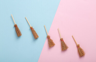 Minimal halloween still life. Creative layout of witch brooms on two tone pastel background. Top view
