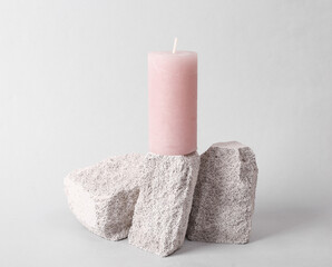 Abstract nature scene with composition of Candle on stones. Minimal modern still life