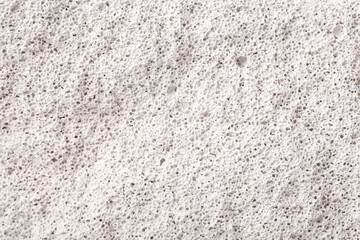 Texture of white porous stone closeup.