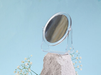 Mirror on stone, blue background. Product photo. Abstract natural composition. Minimal beauty still life