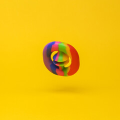 Antistress sensory snapperz toy flying in antigravity on yellow background with shadow. Levitation object in the air. Creative minimal layout