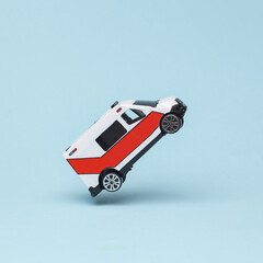 Miniature ambulance model flying in antigravity on blue background with shadow. Levitation object...
