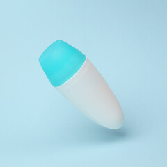 Antiperspirant stick mockup flying in antigravity on blue background with shadow. Levitation object in the air. Beauty concept. Creative minimal layout