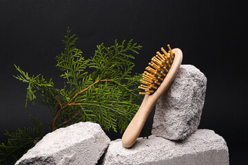 Hair brush on stone with fir branch. Beauty concept. Modern still life, product photo. Aesthetic...