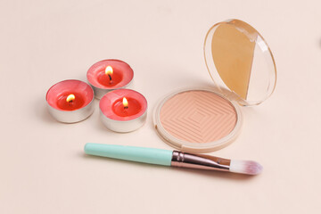 Spa salon, beauty concept. Powder box with aroma candles on a beige background