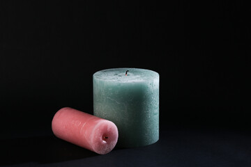 Two candles on a black background