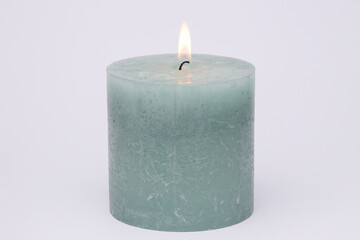 Flaming wax candle on white background