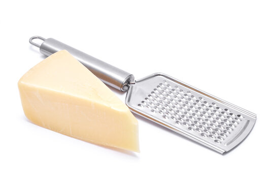 Piece of parmesan cheese and grater isolated on white background