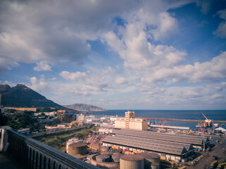 Oran's commercial port during the autumn against cloudy sky with mountains in the background
