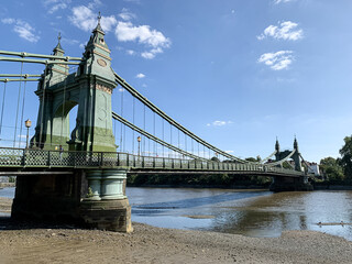 Hammersmith Bridge is a suspension bridge that crosses the River Thames in West London, England, UK