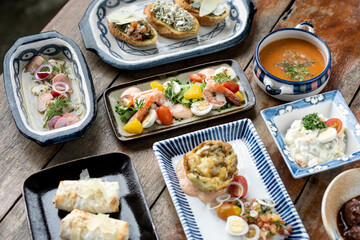 selection of many different tapas on rustic wood table