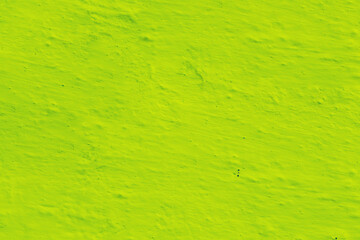 Abstract background of yellow-green plaster.