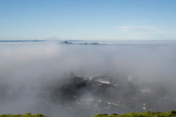 One Tree Hill in a sea of fog, view from Mt Eden summit, Auckland.