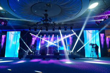 preparation of the stage in a dark banquet hall. 