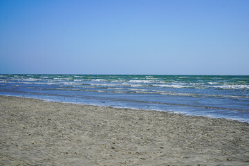 View of the ocean lapping on a sandy shore 