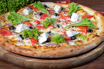 Pizza with bacon and cheese, herbs and cherry tomatoes. With mozzarella, shrimp and octopus, mussels and other products on a wooden background.