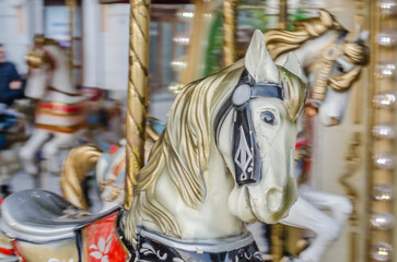 Fototapeta na wymiar The decorations on the children's carousel with wooden horses