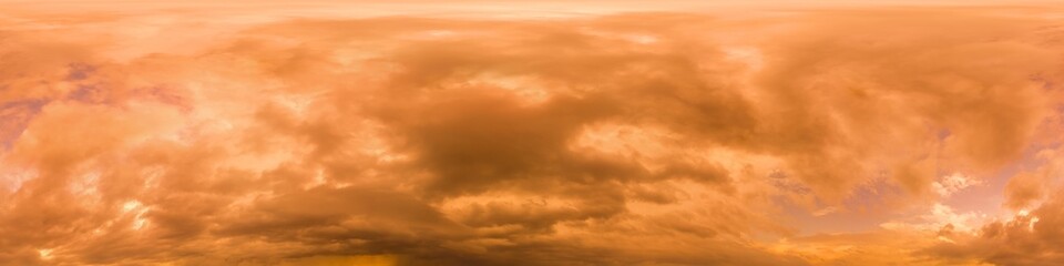 Obraz premium Golden glowing red orange overcast sunset sky panorama. Hdr seamless spherical equirectangular 360 panorama. Sky dome or zenith for 3D visualization and sky replacement for aerial drone 360 panoramas.