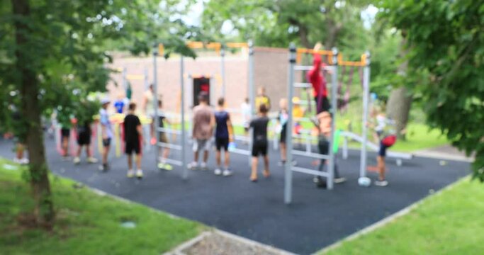 School-age children play sports in the playground. Happy teenagers play together outdoors. Out of focus 4k