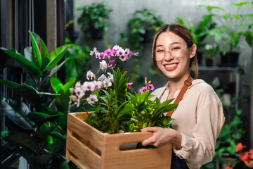 Beautiful cute female asian Gardeners are preparing small planters.Hobby of plant, gardening  at home.