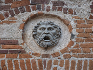 Ancient mask at Ricetto medieval village in Candelo - obrazy, fototapety, plakaty