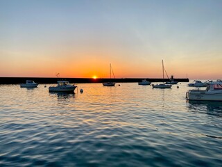 boats at sunset in a port