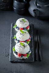 Unique sushi burger with raspberries and blueberries as Japanese cuisine.