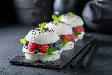 Fresh sushi burger with sesame and berries sprinkled with seeds.