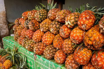 Pile of fresh pineapples on display at street market in Madagascar