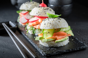 Delicious sushi burger with vegetables and seafood as Japanese appetizers.
