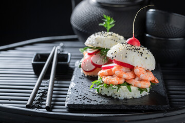 Delicious sushi burger with seafood and rice as Japanese appetizers.