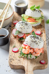 Healthy sushi burger with seafood and rice on strone plate.
