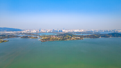 Aerial photography of Bogong Island Ecological Park, Yuantouzhu Scenic Area and the city center building complex in Wuxi City, Jiangsu Province, China